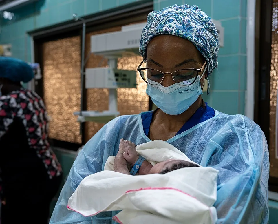 A midwife holding a newborn